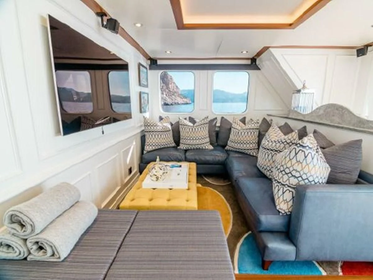 a living room with a couch and a table aboard CHARISMA Yacht for Sale