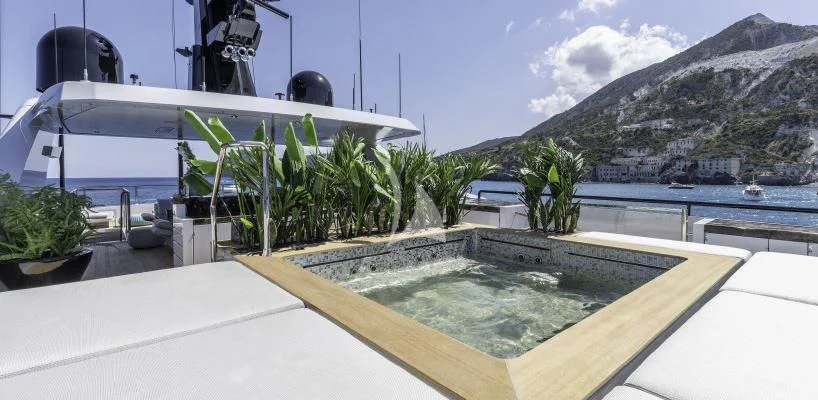 a pool with a building in the background aboard LEL Yacht for Sale