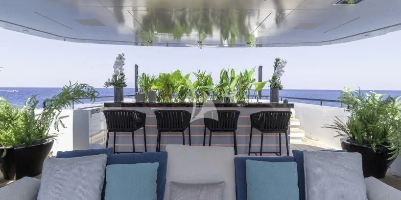 a room with a table chairs and plants aboard LEL Yacht for Sale