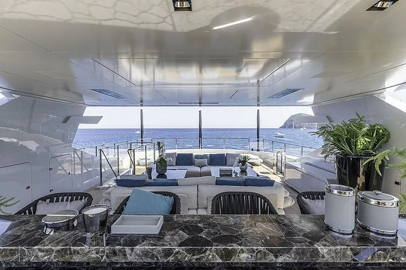 a room with a large table and chairs and a large window aboard LEL Yacht for Sale