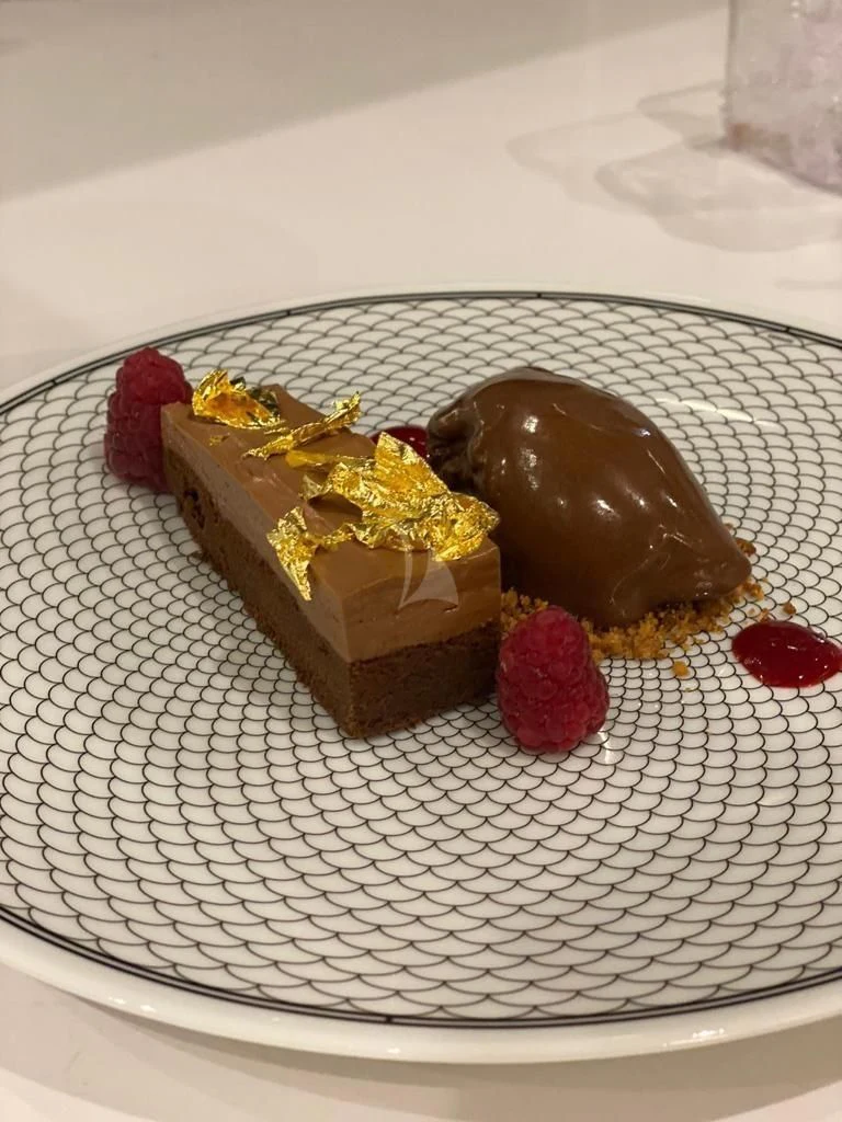 a chocolate cake with fruit on top aboard LEL Yacht for Sale