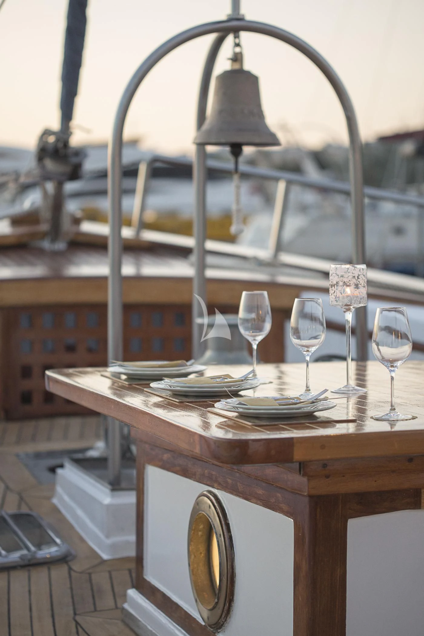 a table with plates and glasses on it aboard COSMOS Yacht for Sale