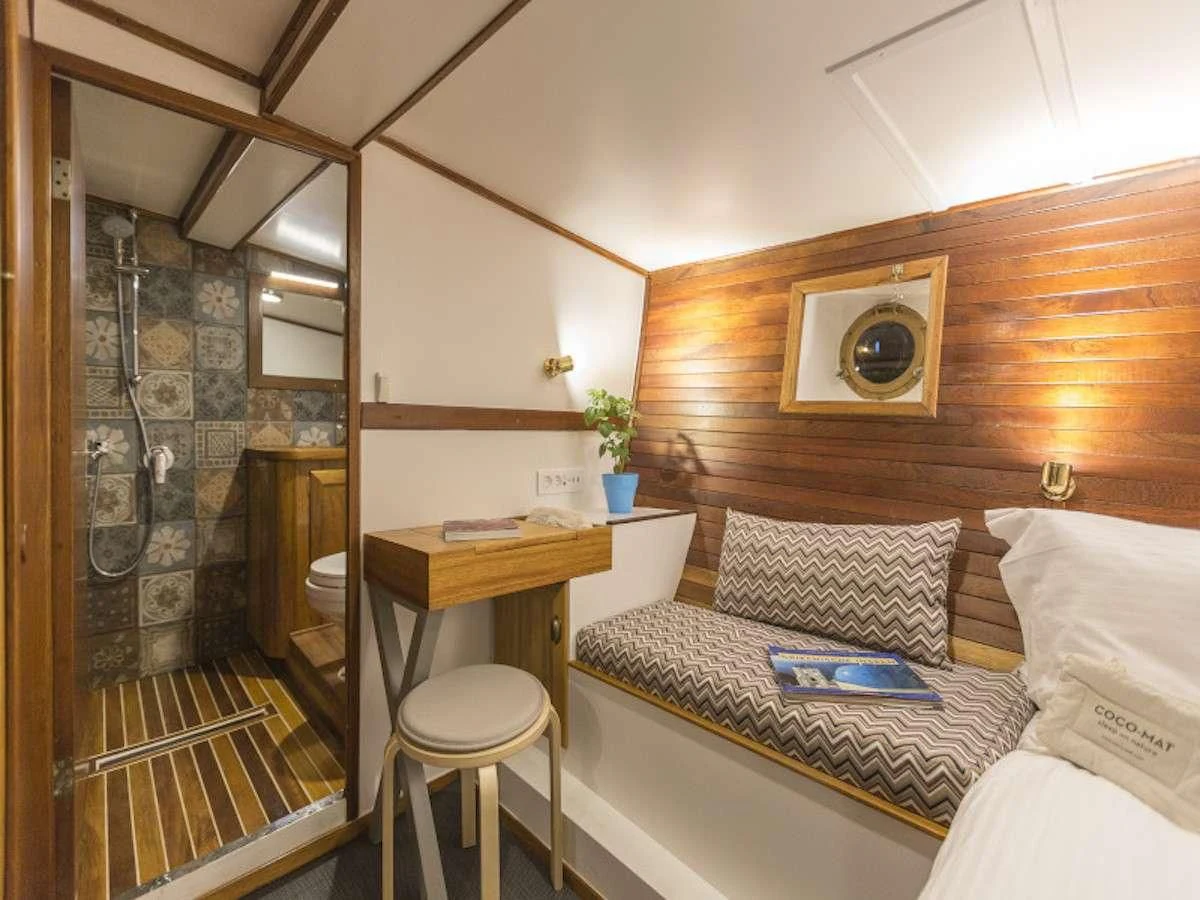a bed in a room aboard COSMOS Yacht for Sale