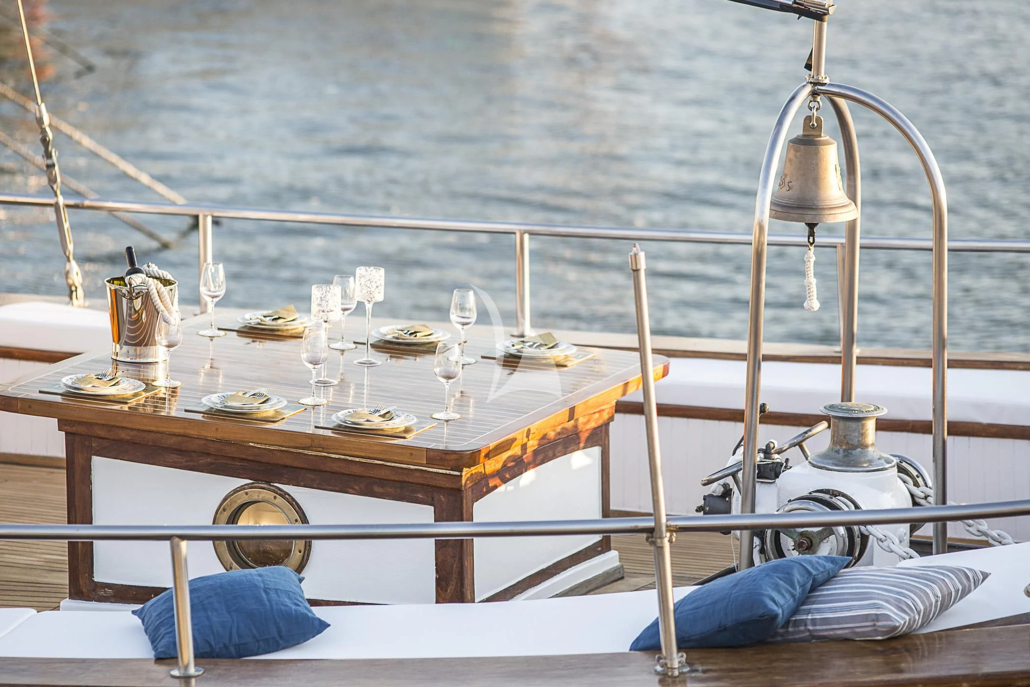 a table with food and glasses on it aboard COSMOS Yacht for Sale