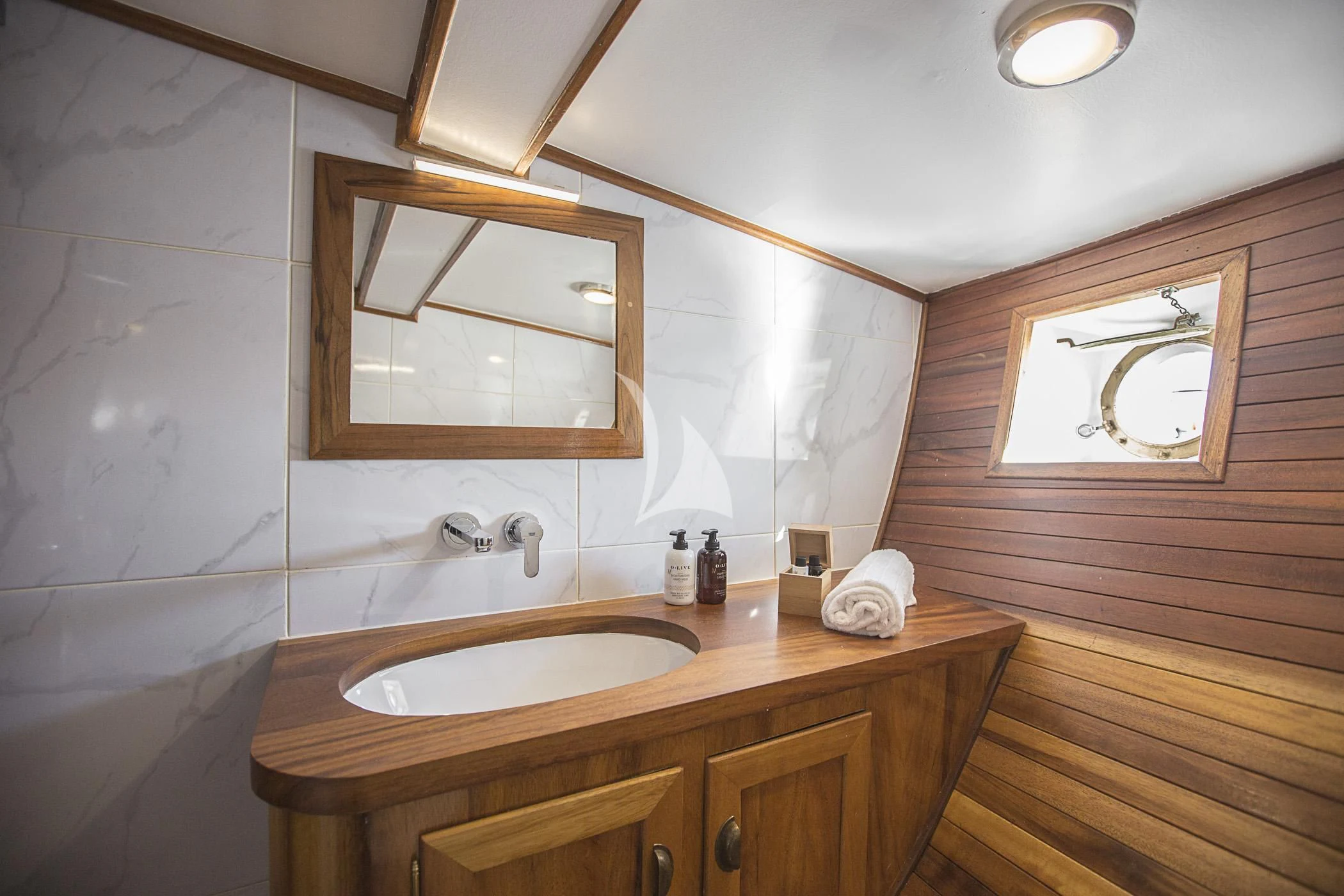 a bathroom with a sink and a mirror aboard COSMOS Yacht for Sale