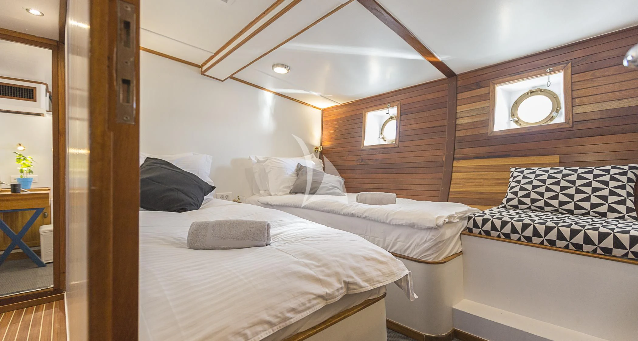 a room with two beds aboard COSMOS Yacht for Sale