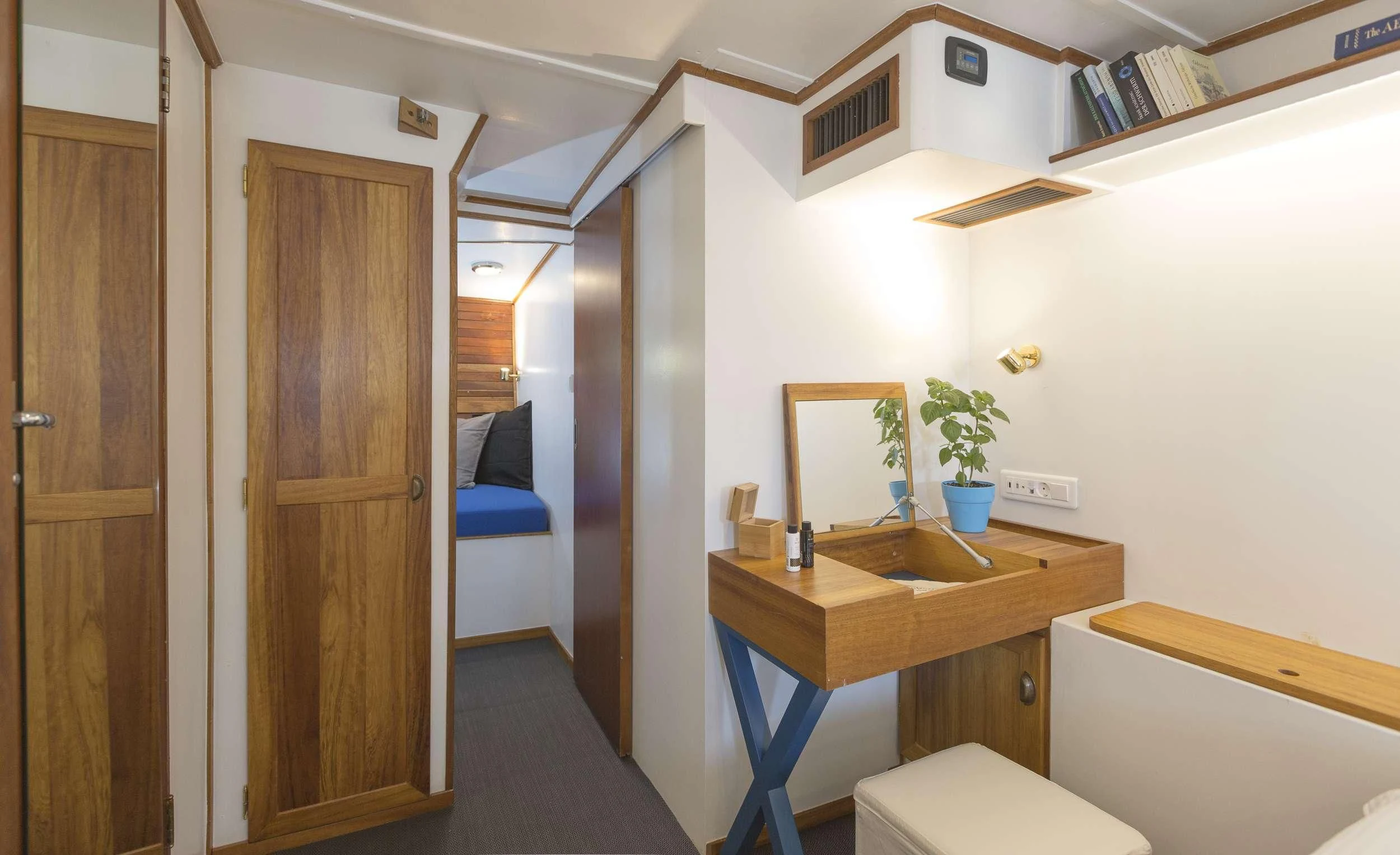a small bathroom with a sink and a bed aboard COSMOS Yacht for Sale