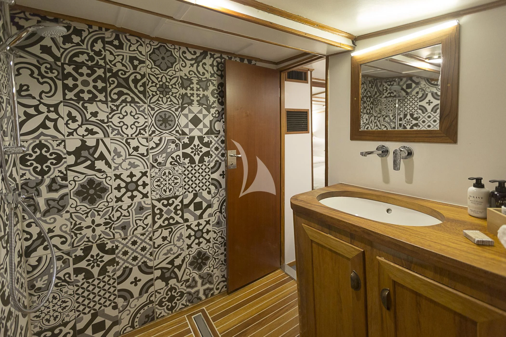 a bathroom with a marble shower curtain aboard COSMOS Yacht for Sale