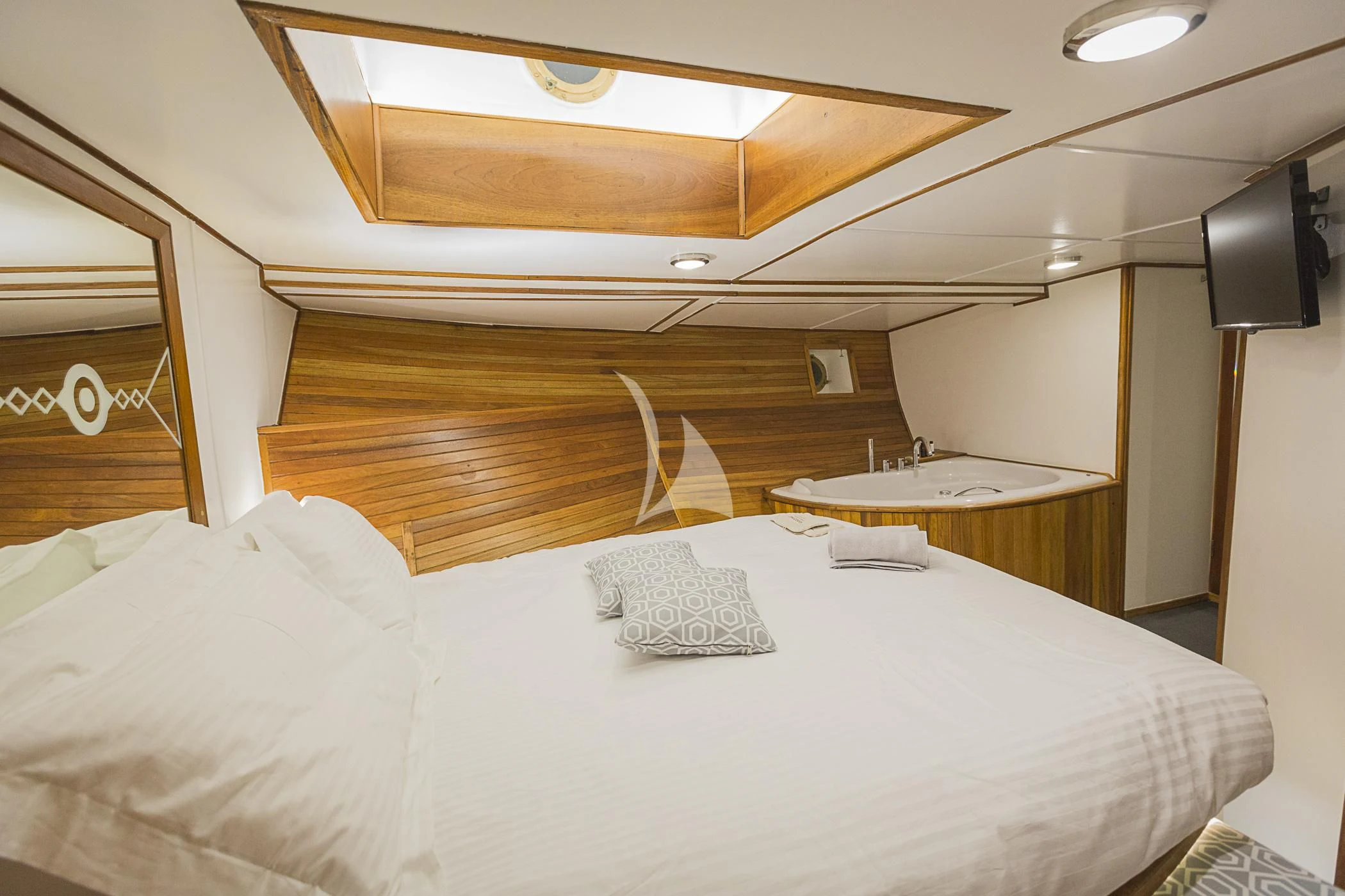 a bed with white sheets aboard COSMOS Yacht for Sale