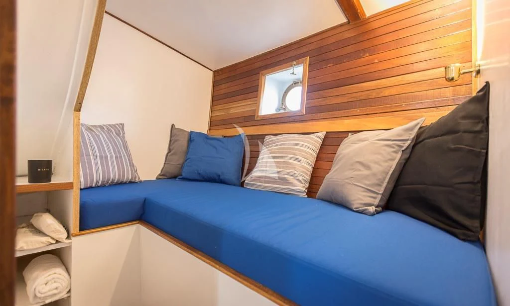 a bed with pillows aboard COSMOS Yacht for Sale