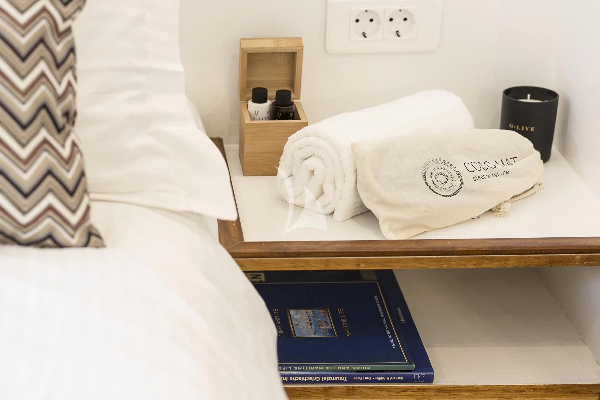 a bed with a towel on it aboard COSMOS Yacht for Sale