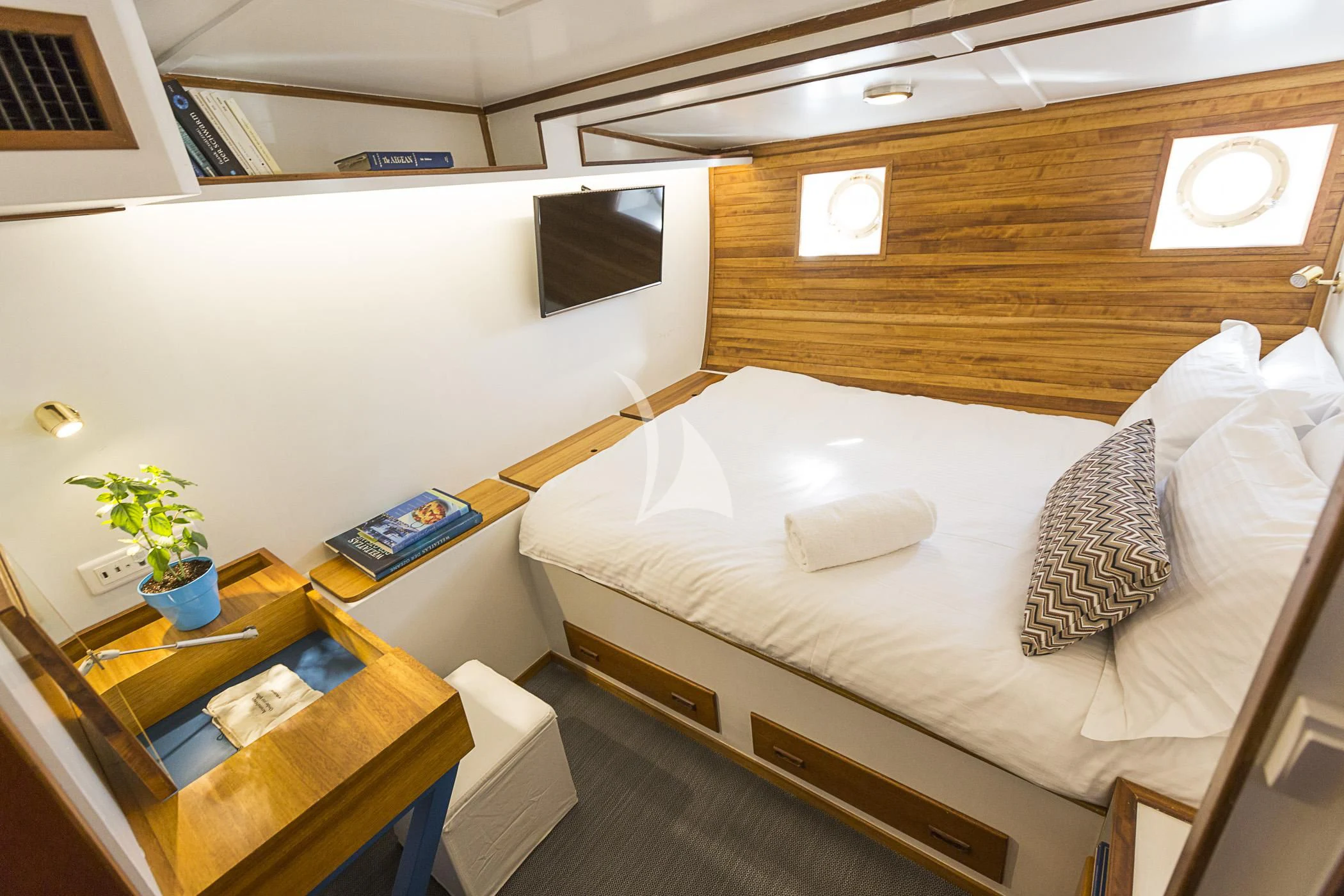 a room with a bed and a desk aboard COSMOS Yacht for Sale