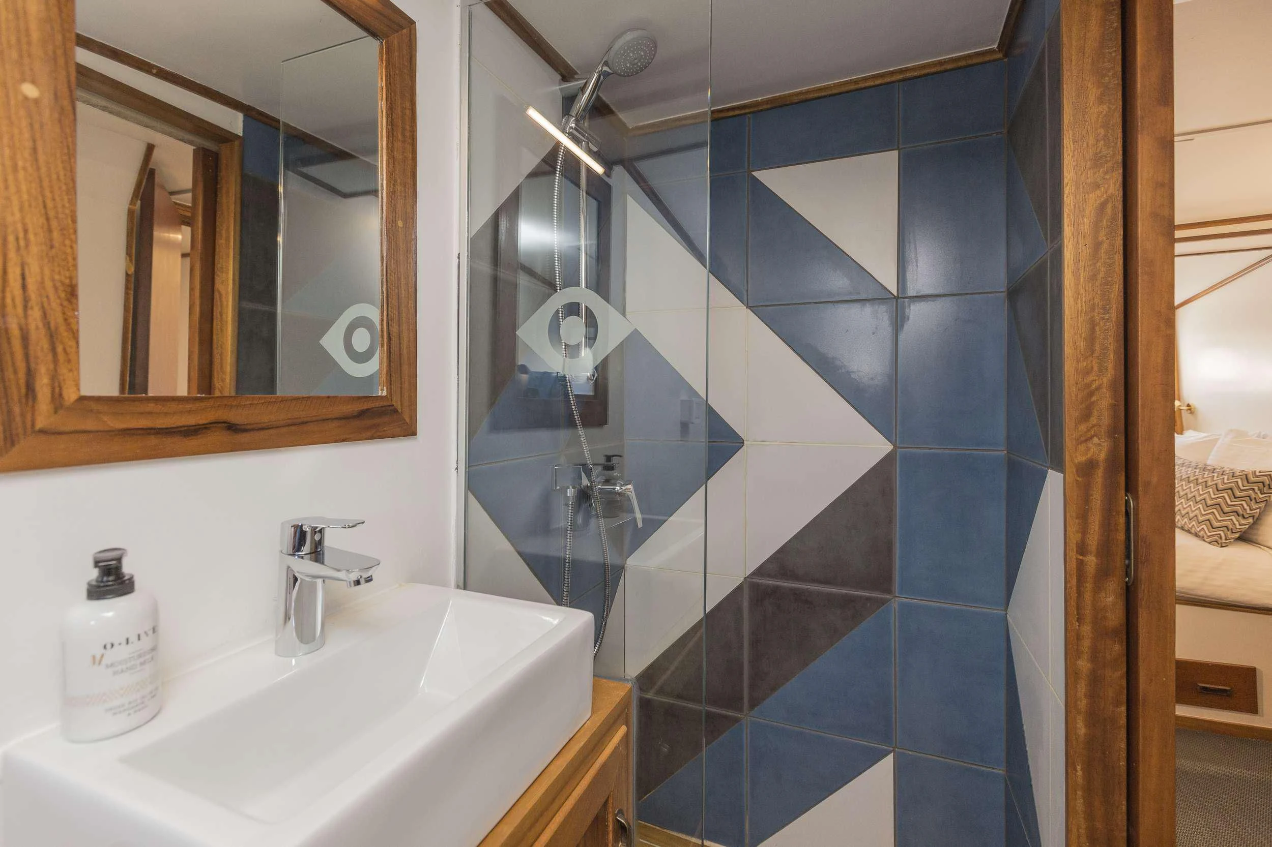 a bathroom with a large mirror aboard COSMOS Yacht for Sale
