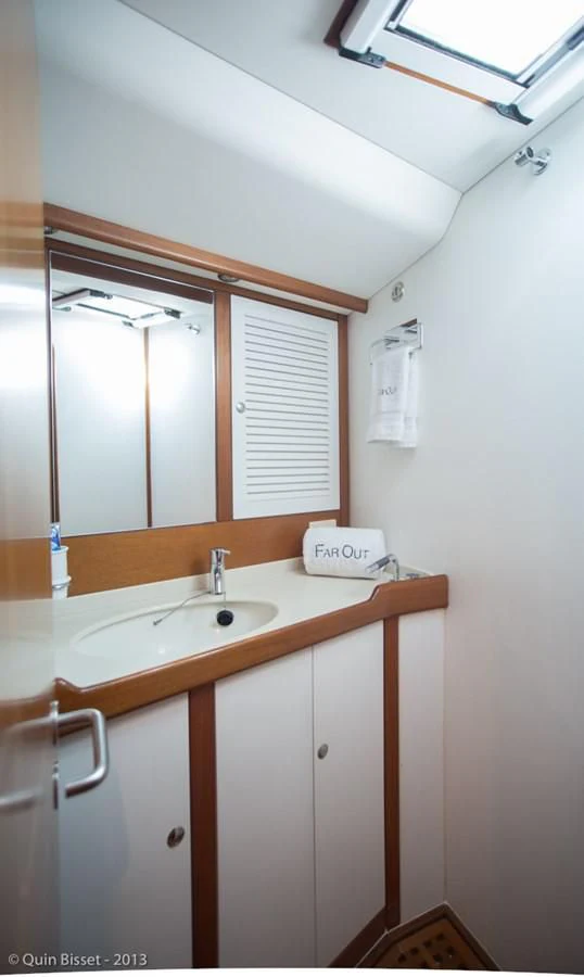 a bathroom with a sink and a mirror aboard FAR OUT Yacht for Sale