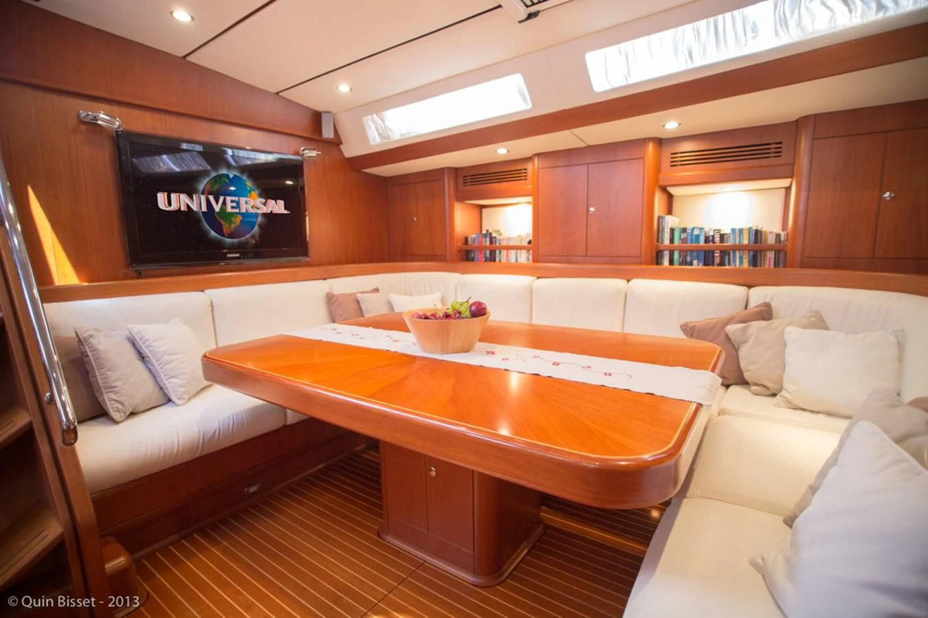 a room with a table and couches aboard FAR OUT Yacht for Sale
