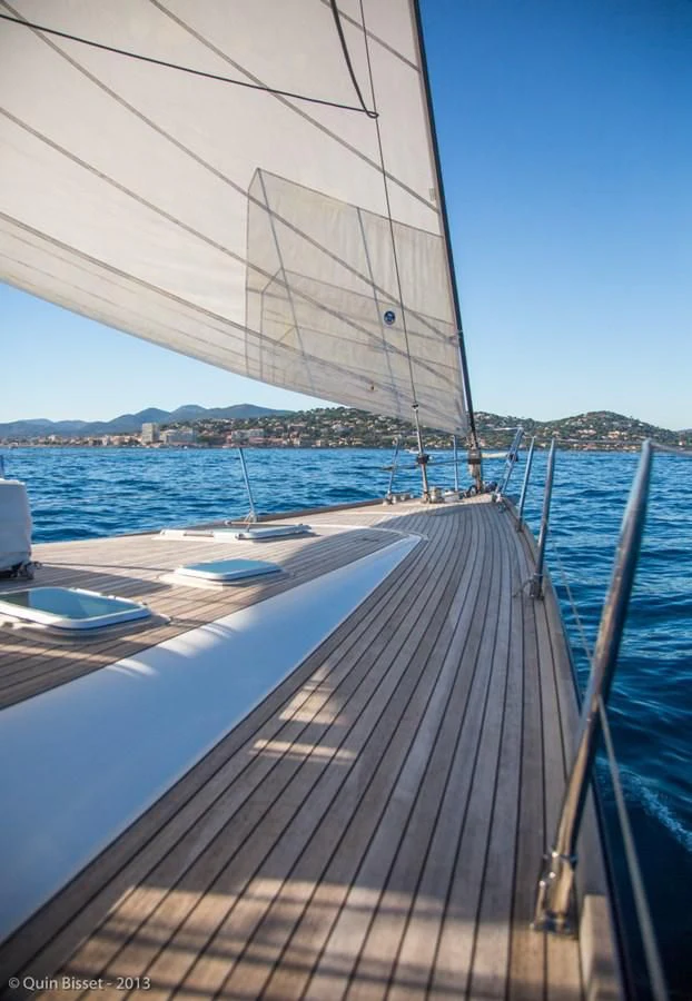 a deck with a sailboat on it and a city in the background aboard FAR OUT Yacht for Sale