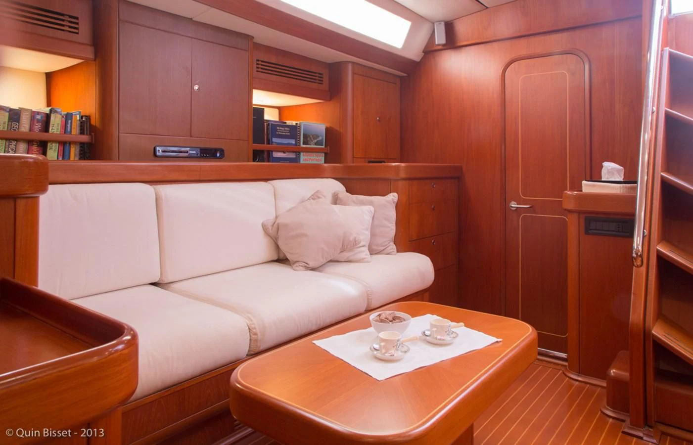 a living room with a couch and coffee table aboard FAR OUT Yacht for Sale