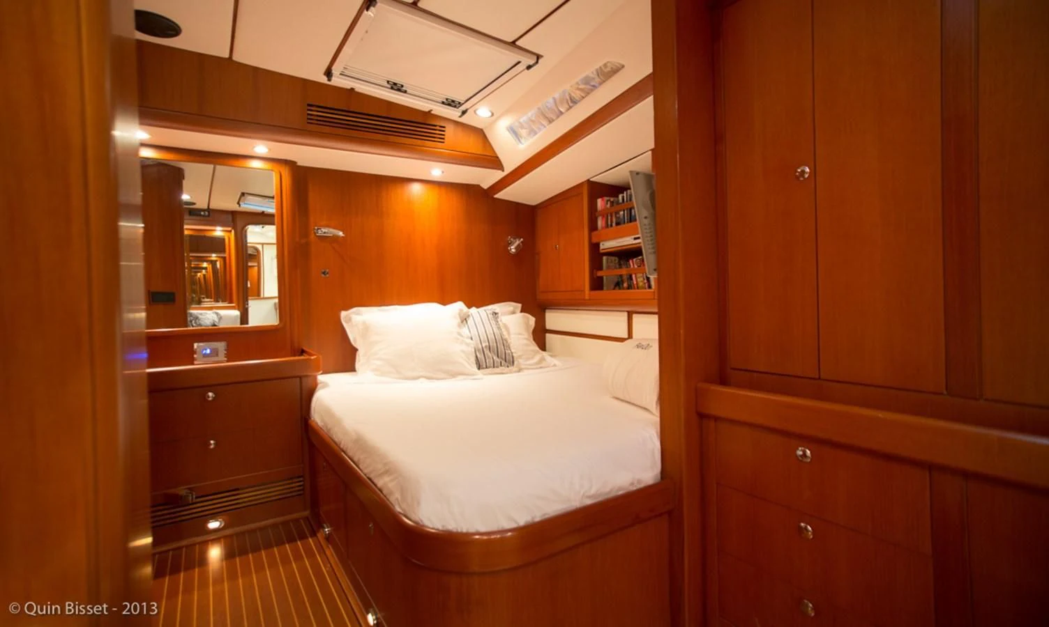 a room with a bed and a bookcase aboard FAR OUT Yacht for Sale
