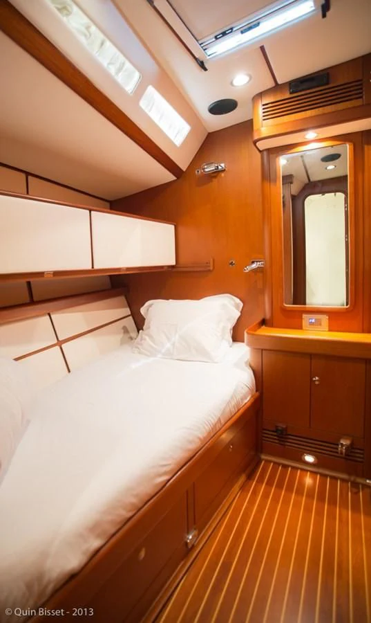 a room with a bed and a mirror aboard FAR OUT Yacht for Sale