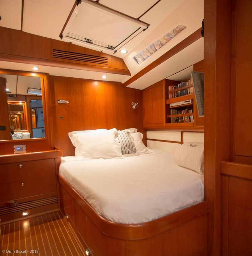 a room with a bed and a bookcase aboard FAR OUT Yacht for Sale