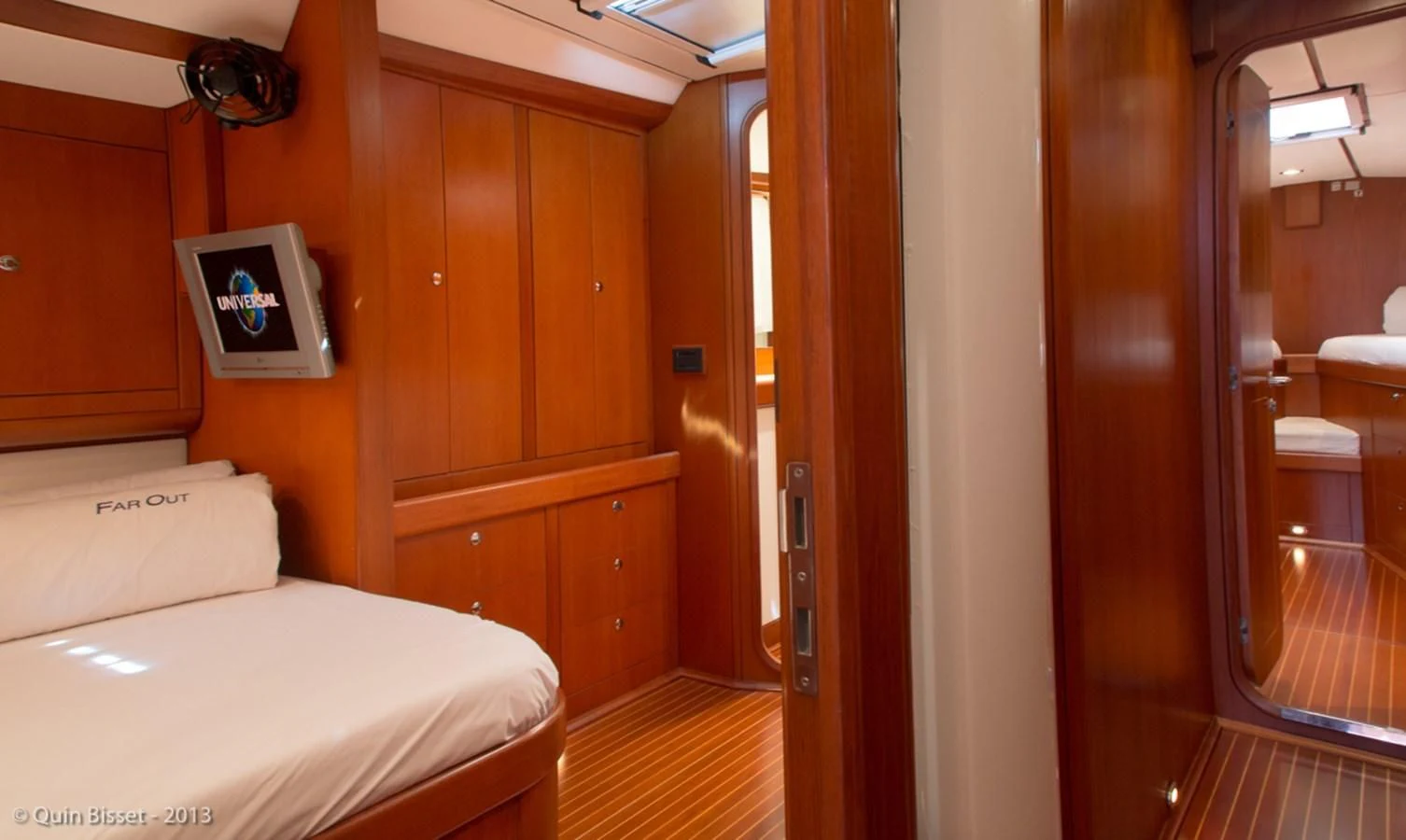 a room with a bed and a mirror aboard FAR OUT Yacht for Sale