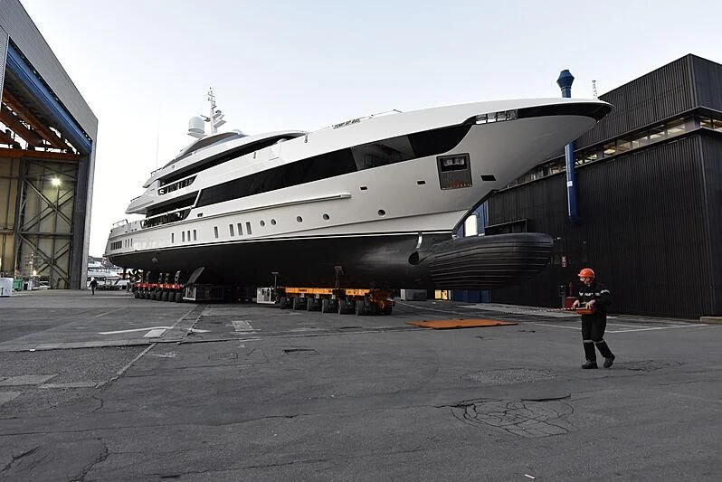 a person standing next to a large white ship aboard ORAS Yacht for Sale