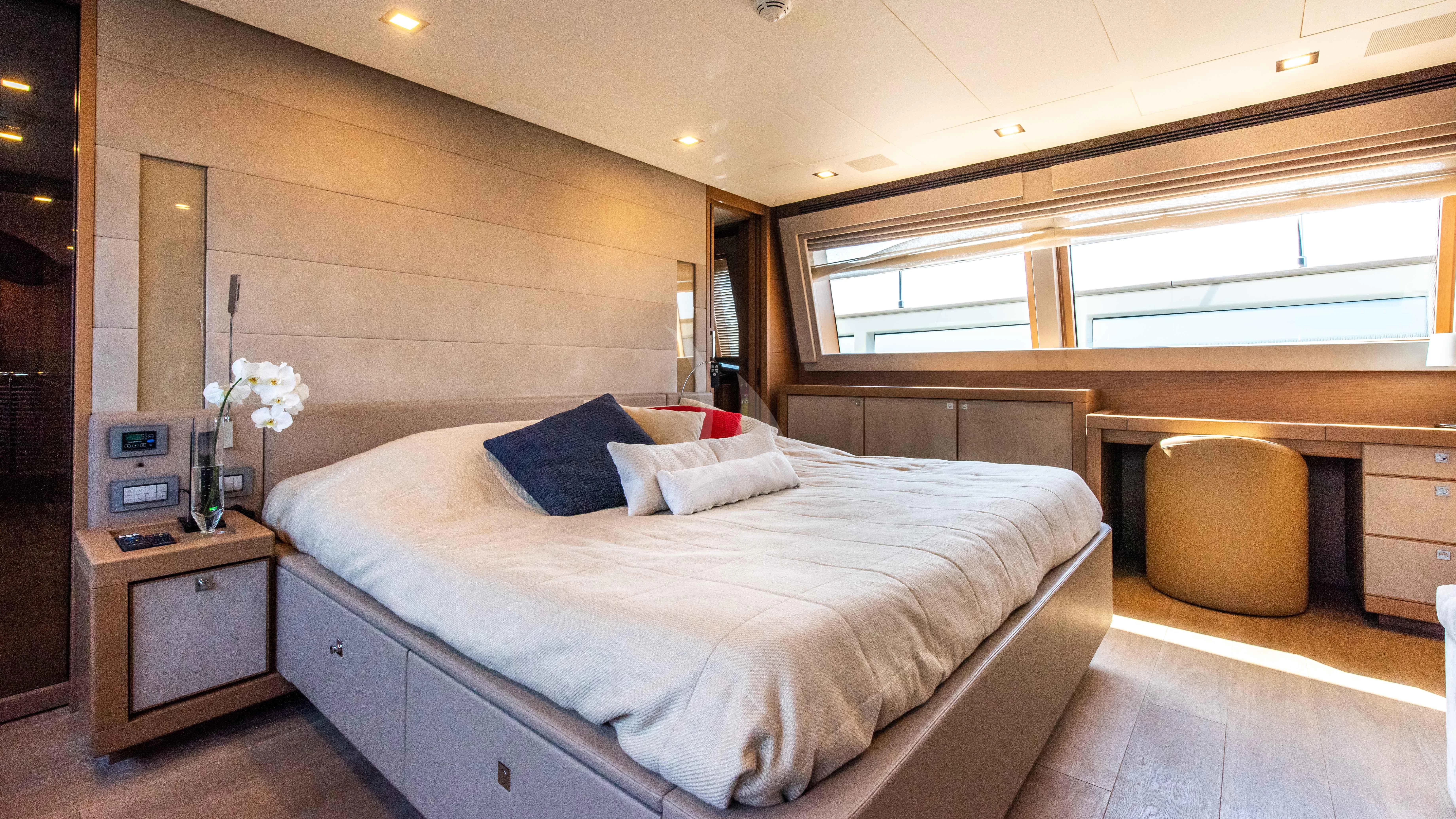a bedroom with a bed and a desk aboard THALYSSA Yacht for Charter