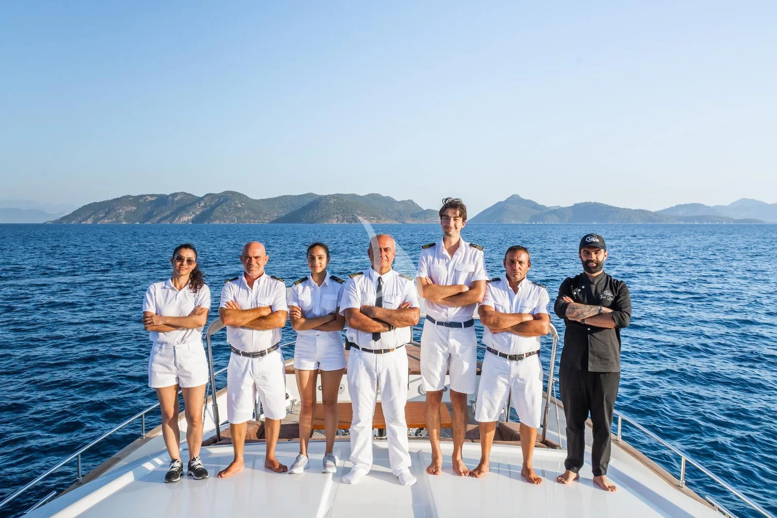 a group of people posing for a photo on a boat aboard THALYSSA Yacht for Charter