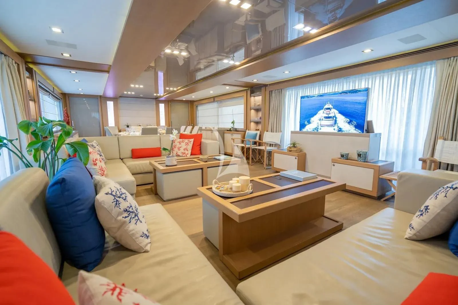 a living room with a large screen aboard THALYSSA Yacht for Charter