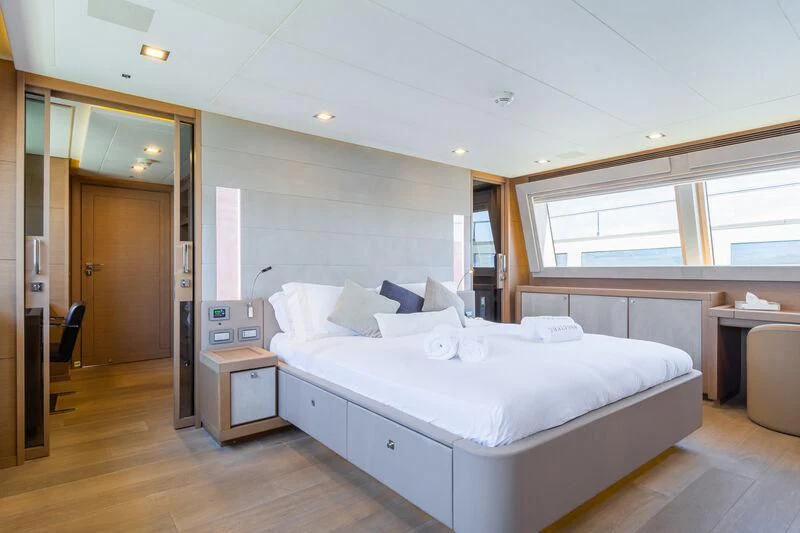 a room with a bed and a desk aboard THALYSSA Yacht for Charter