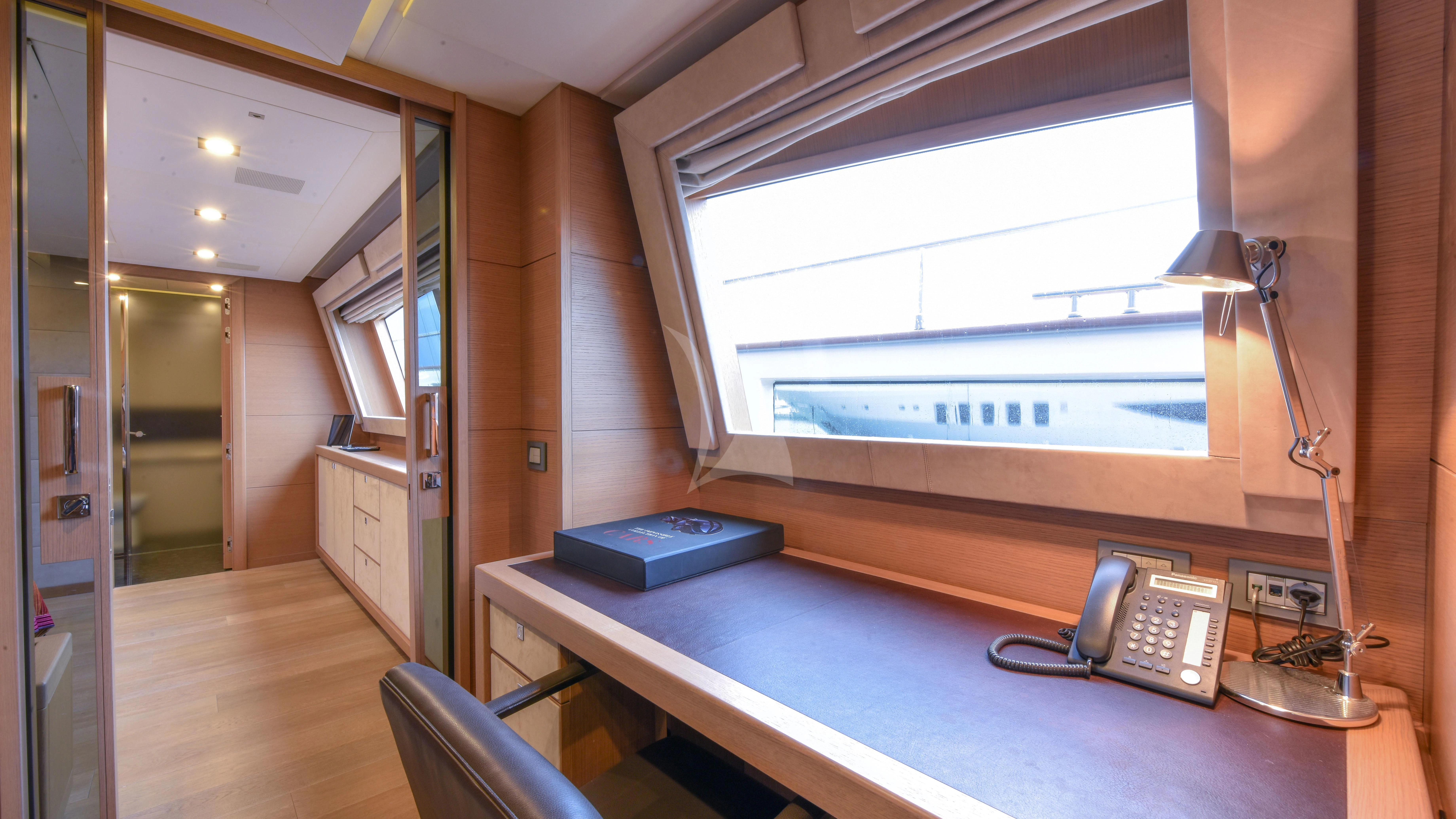 a desk with a phone and a phone on it aboard THALYSSA Yacht for Charter
