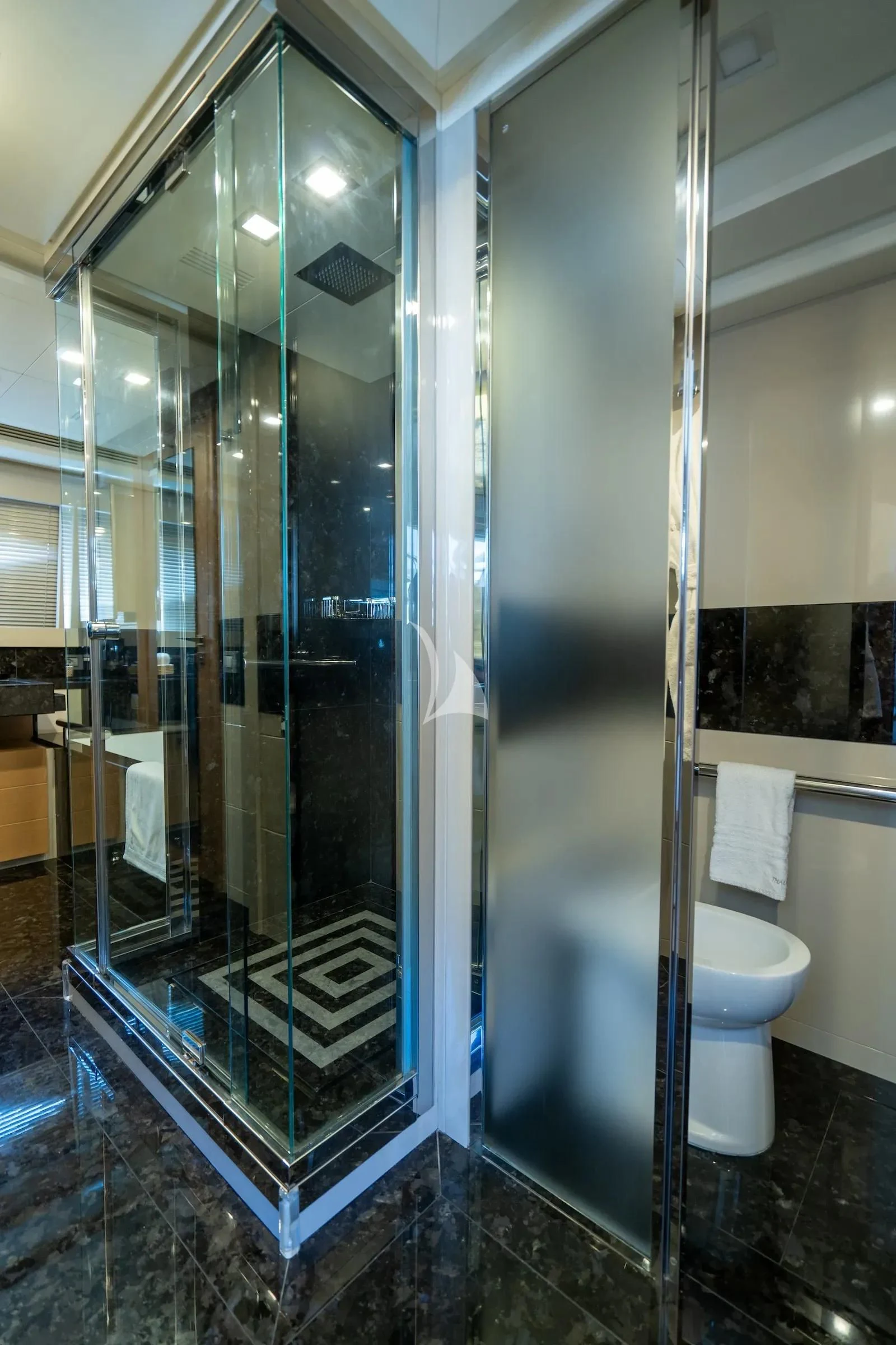a bathroom with a glass shower aboard THALYSSA Yacht for Charter
