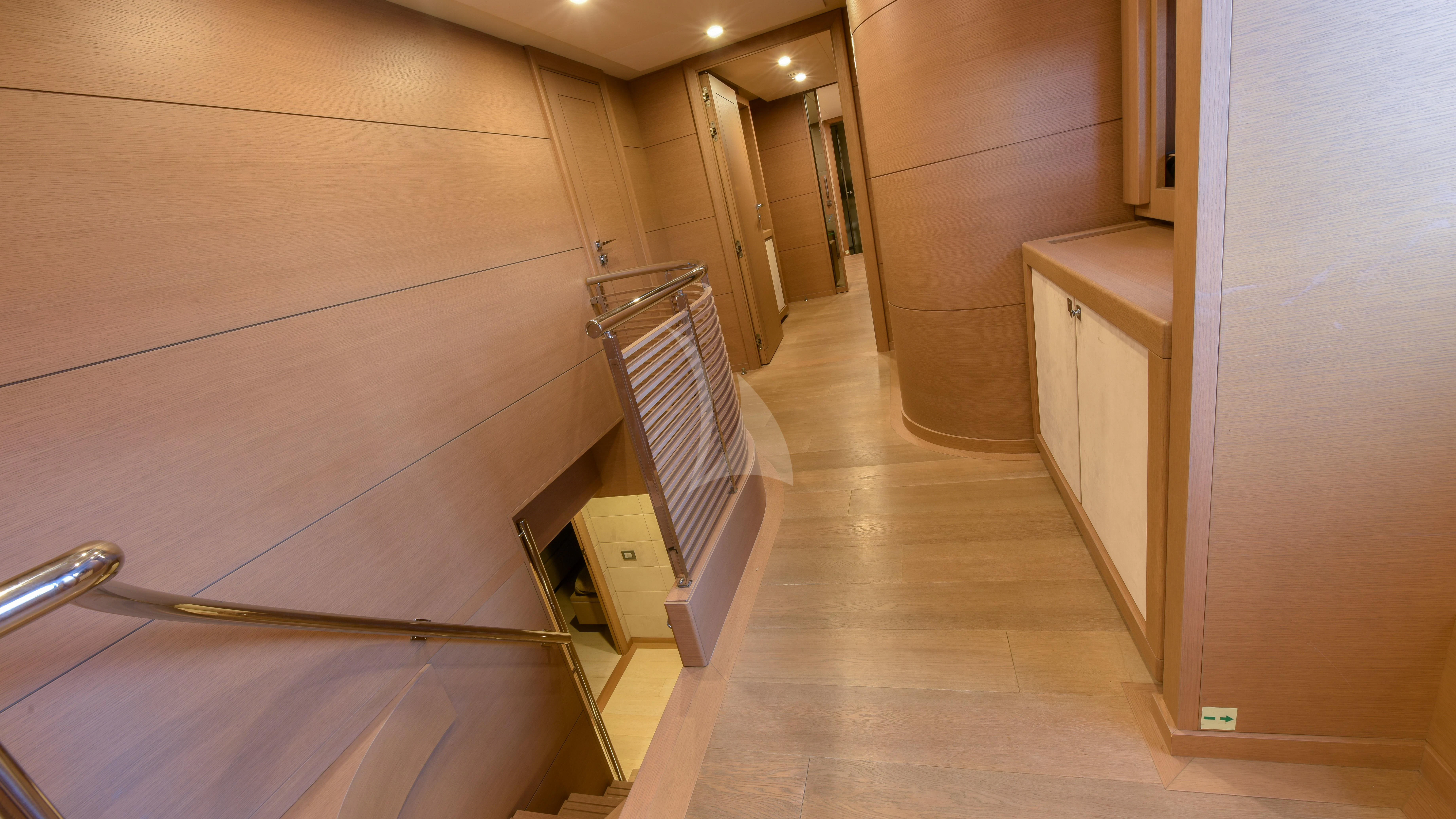 a hallway with a door and a staircase aboard THALYSSA Yacht for Charter