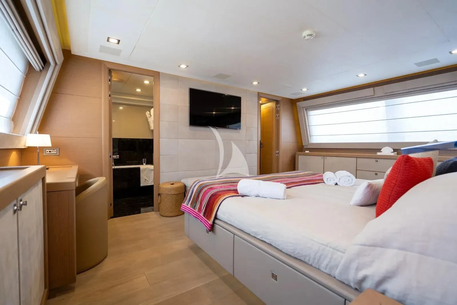 a bedroom with a bed and a television on the wall aboard THALYSSA Yacht for Charter