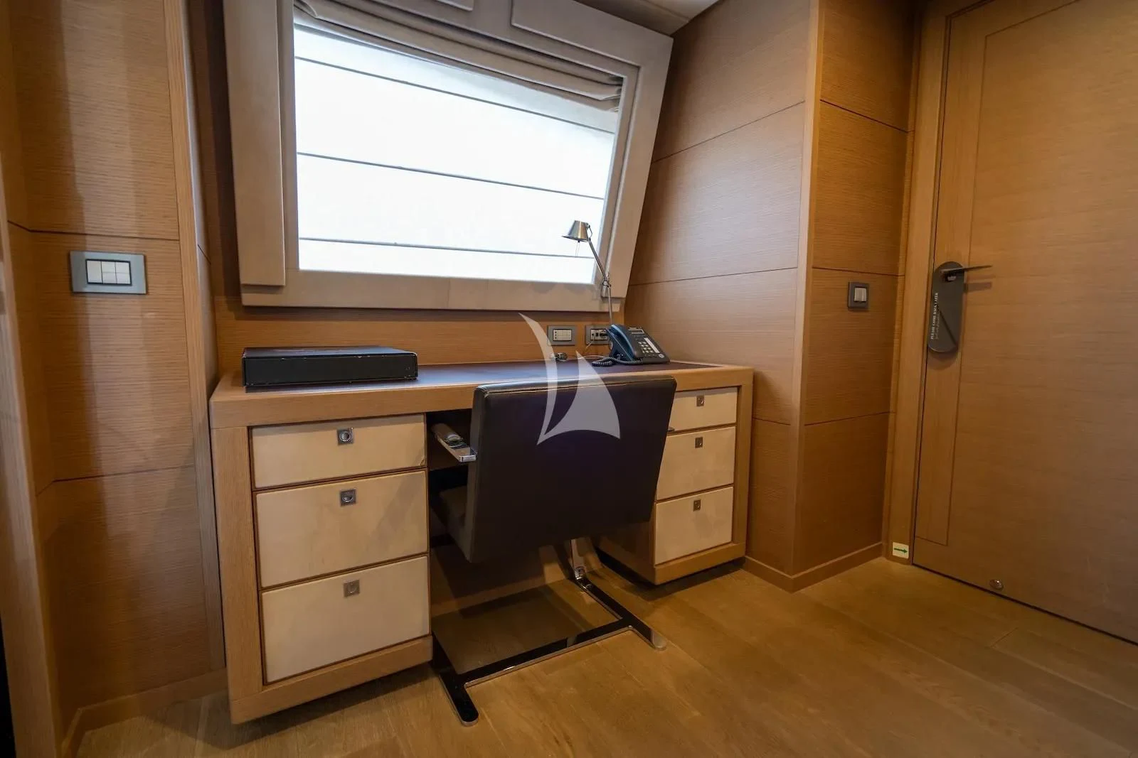 a desk with a chair and a computer on it aboard THALYSSA Yacht for Charter