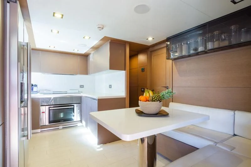 a kitchen with a table and a microwave aboard THALYSSA Yacht for Charter