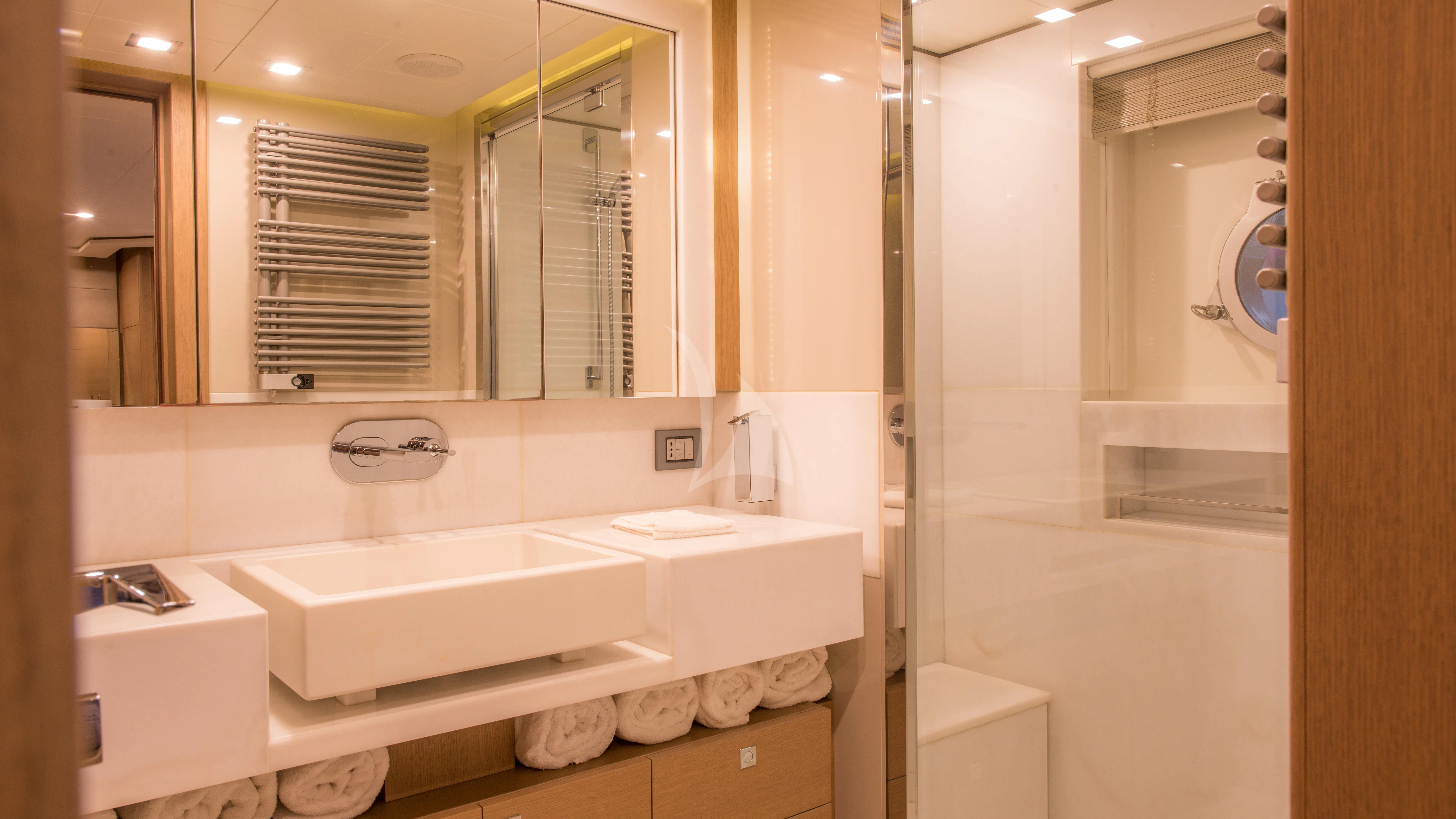 a bathroom with a tub sink and a mirror aboard THALYSSA Yacht for Charter