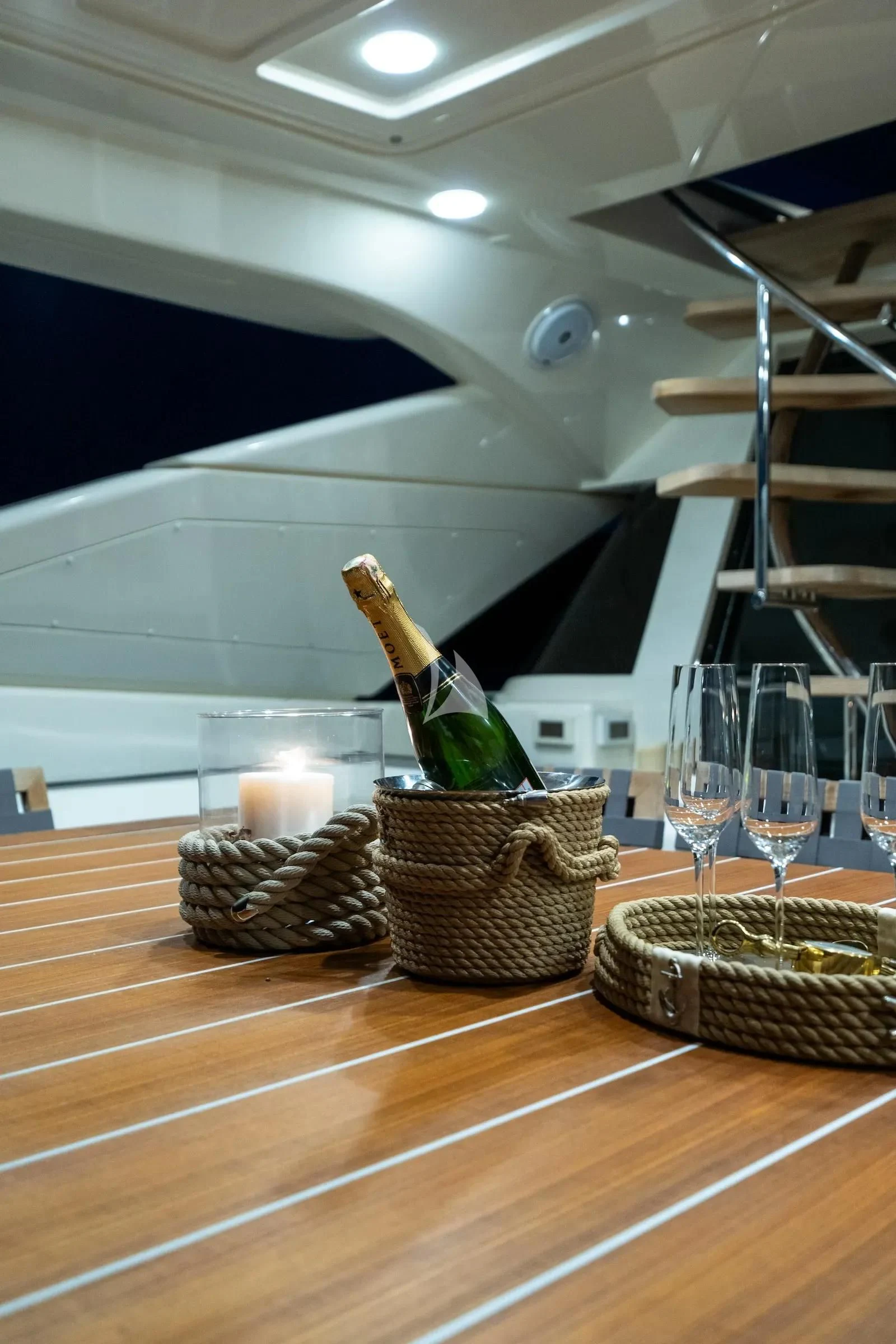 a basket of food and glasses on a table aboard THALYSSA Yacht for Charter