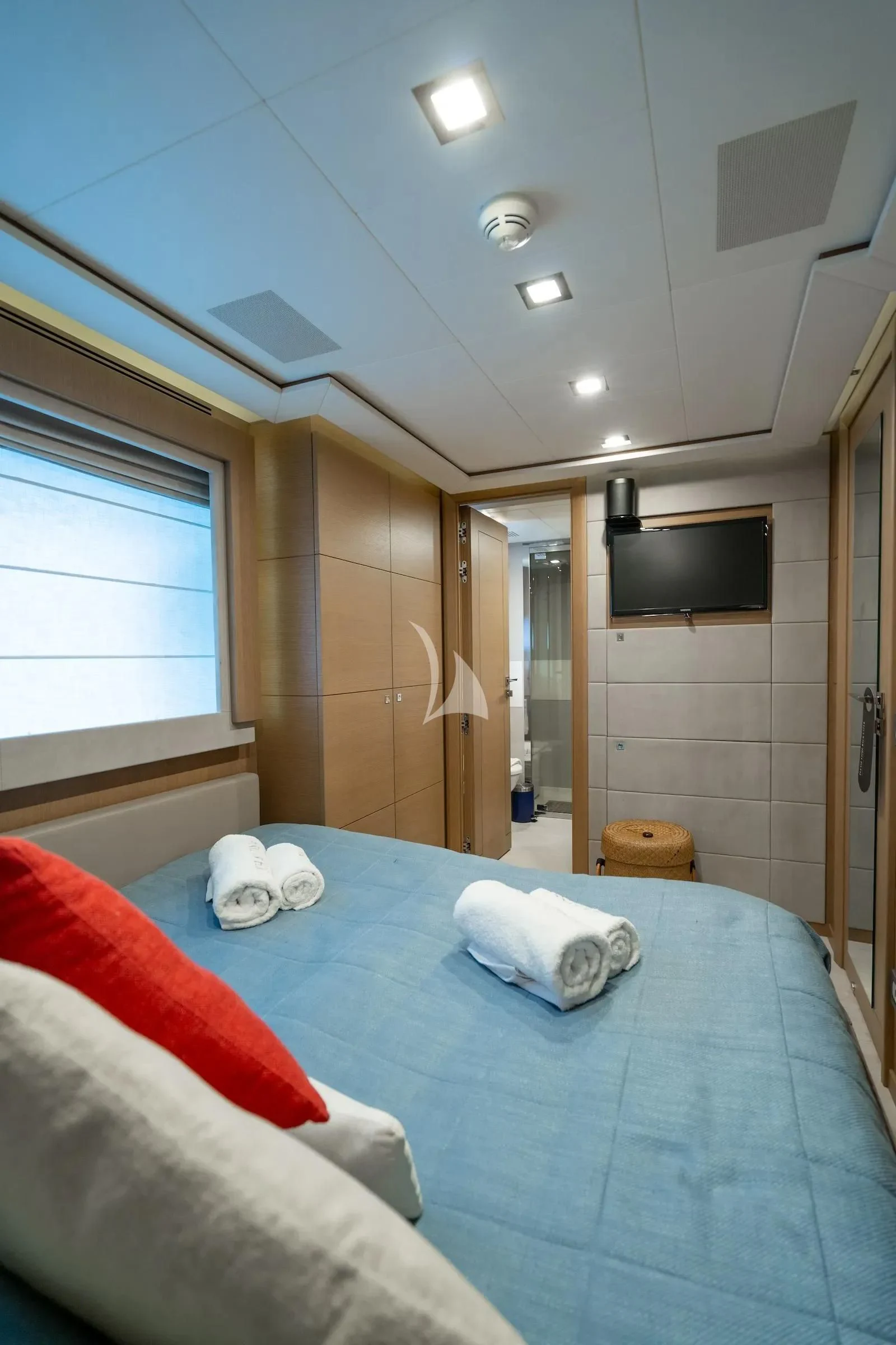a bedroom with a blue bed aboard THALYSSA Yacht for Charter