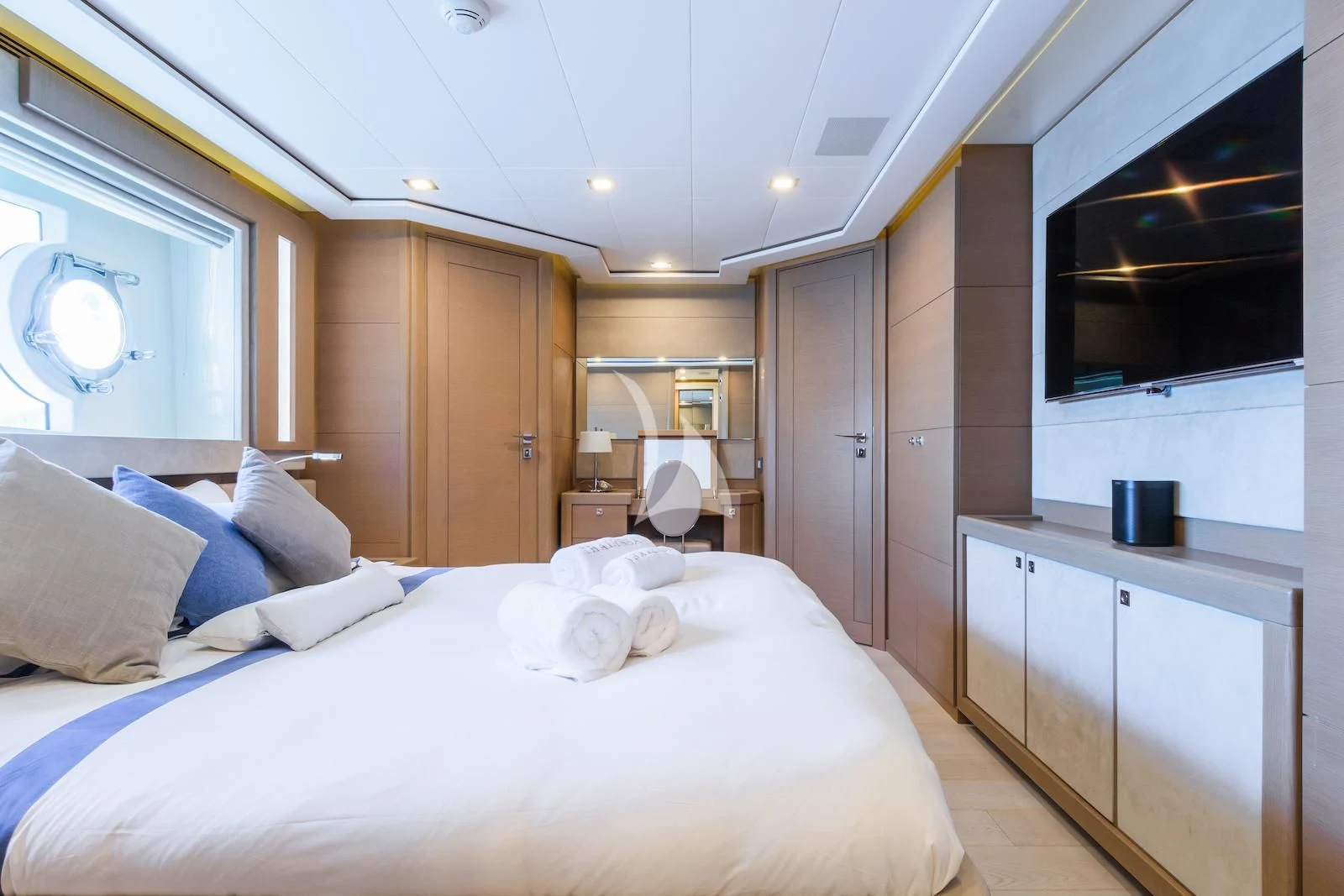 a bedroom with a bed and a television aboard THALYSSA Yacht for Charter