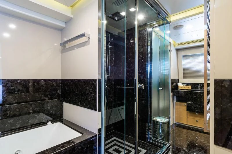 a bathroom with a glass shower aboard THALYSSA Yacht for Charter