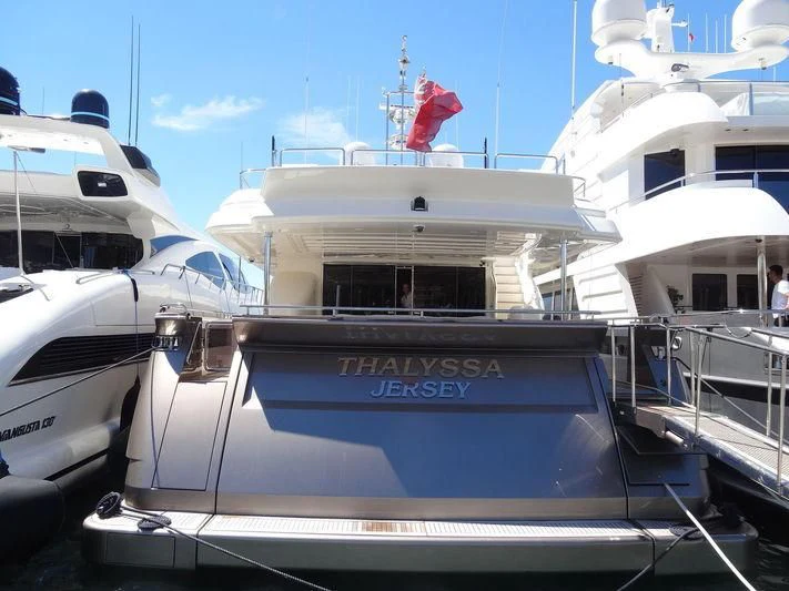 a boat with a flag on the front aboard THALYSSA Yacht for Charter