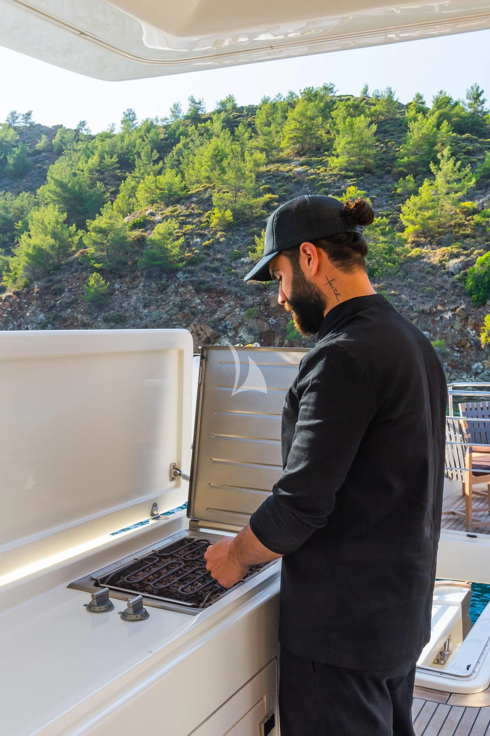 a man looking at a stove aboard THALYSSA Yacht for Charter
