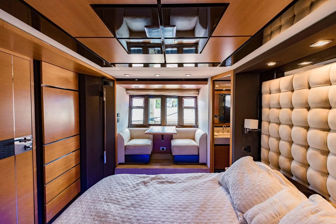 a bedroom with a bed and a desk aboard SYLVIA VI Yacht for Sale