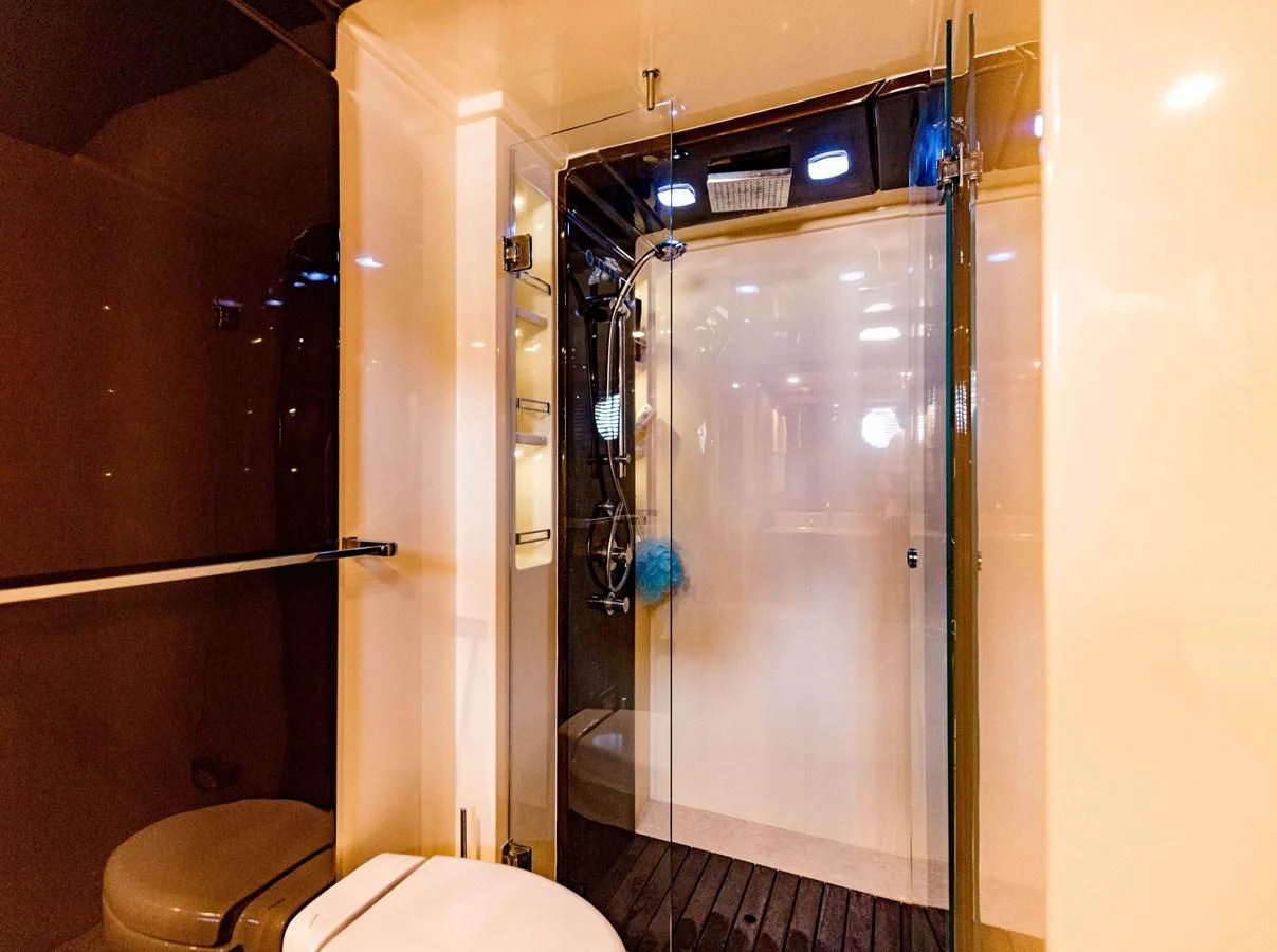 a bathroom with a glass shower aboard SYLVIA VI Yacht for Sale