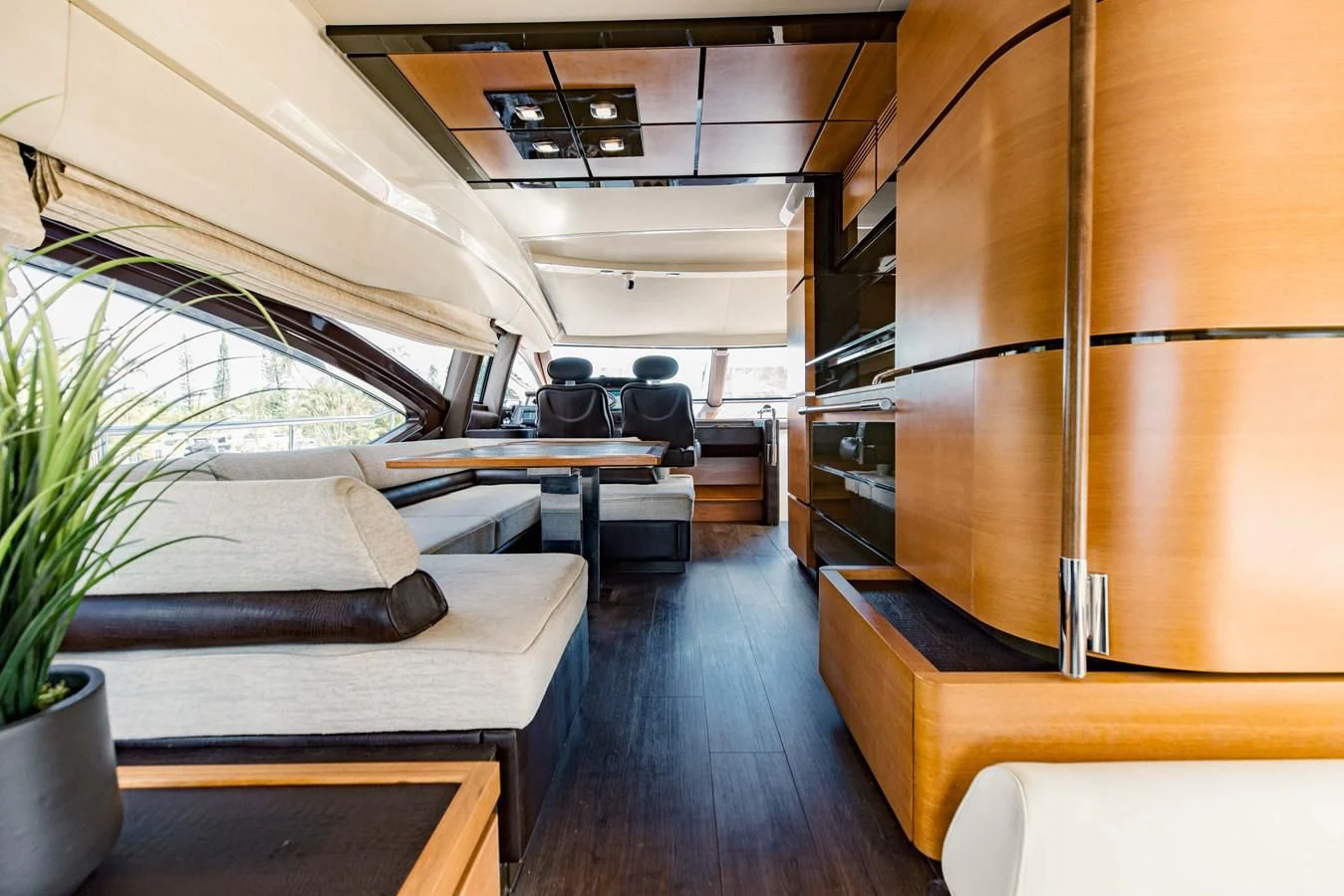 a room with a wood floor and a couch and a table aboard SYLVIA VI Yacht for Sale