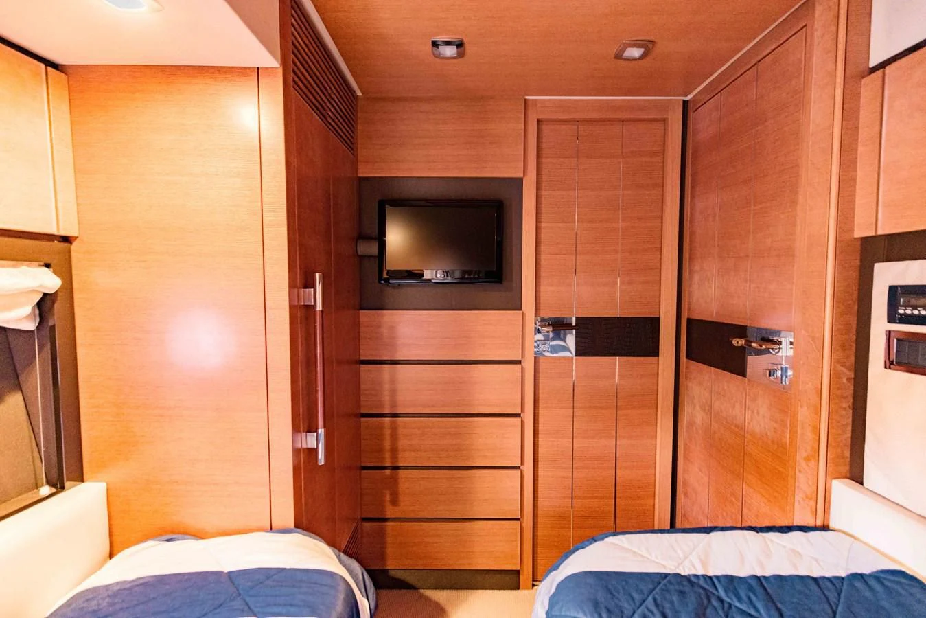 a room with a wood closet and a bed aboard SYLVIA VI Yacht for Sale
