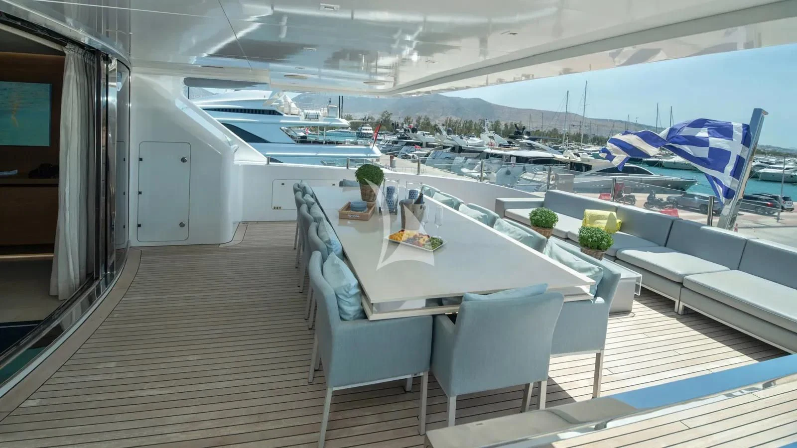 a room with a table chairs and a person sitting at a desk aboard IPANEMAS Yacht for Sale
