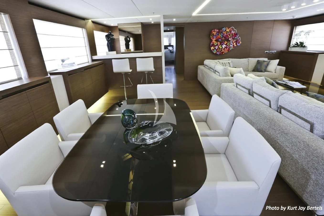 a living room with a large table aboard IPANEMAS Yacht for Sale