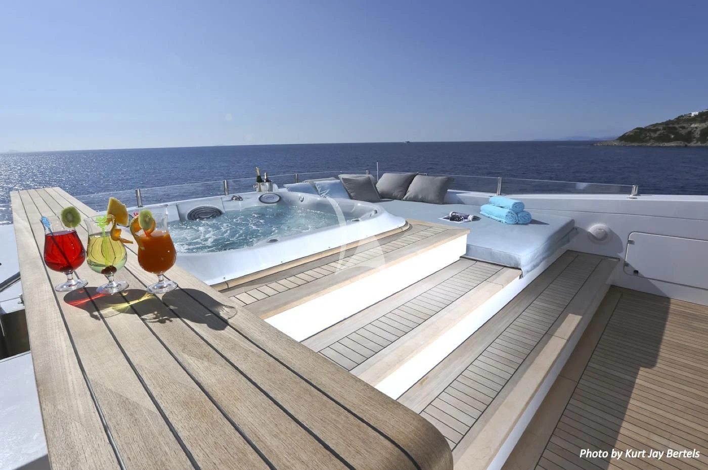 a deck with a pool and chairs aboard IPANEMAS Yacht for Sale